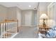 Upstairs hallway with wooden railing, neutral walls and trim, and a cozy reading nook at 6513 Sand Shore Ln, New Port Richey, FL 34652