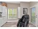 Bright kitchen area with modern appliances, a massage chair, and an exit door to an outdoor space at 6513 Sand Shore Ln, New Port Richey, FL 34652