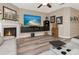 Modern living room featuring a fireplace, large TV, stylish decor, and cozy seating at 6513 Sand Shore Ln, New Port Richey, FL 34652