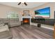Cozy living room with a fireplace, sleek flooring, and modern decor at 6513 Sand Shore Ln, New Port Richey, FL 34652