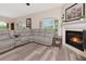 Comfortable living room with a fireplace, sleek flooring, and neutral decor at 6513 Sand Shore Ln, New Port Richey, FL 34652