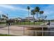 Waterfront view with a manicured lawn and lush landscaping, perfect for enjoying the scenery at 6513 Sand Shore Ln, New Port Richey, FL 34652