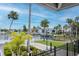 Picturesque waterfront view with lush greenery, palm trees, and various homes and docks at 6513 Sand Shore Ln, New Port Richey, FL 34652