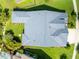 Aerial view of the property with a distinctive gray roof, well-manicured yard, and patio at 6817 Ebb Tide Ave, Apollo Beach, FL 33572