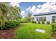 Well-maintained backyard with lush greenery and manicured shrubs at 6817 Ebb Tide Ave, Apollo Beach, FL 33572