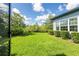 Backyard view showcasing lush lawn and manicured landscaping at 6817 Ebb Tide Ave, Apollo Beach, FL 33572