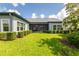 Lush backyard with manicured lawn, trimmed shrubs, and a screened patio, perfect for outdoor enjoyment at 6817 Ebb Tide Ave, Apollo Beach, FL 33572
