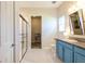 Bright bathroom features a shower, walk-in closet and vanity with granite countertops at 6817 Ebb Tide Ave, Apollo Beach, FL 33572
