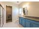 Bright bathroom features a shower, window, and vanity with granite countertops at 6817 Ebb Tide Ave, Apollo Beach, FL 33572