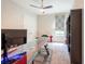Office/bedroom boasts a unique glass desk and a ceiling fan at 6817 Ebb Tide Ave, Apollo Beach, FL 33572