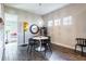 Bright dining area featuring wood floors, a unique light fixture, and a round table with modern chairs at 6817 Ebb Tide Ave, Apollo Beach, FL 33572