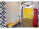 Bright foyer with decorative walls, a stylish bench, and vibrant yellow double doors at 6817 Ebb Tide Ave, Apollo Beach, FL 33572