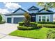 Charming single-story home featuring a well-maintained lawn and a two-car garage at 6817 Ebb Tide Ave, Apollo Beach, FL 33572