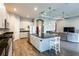 Modern kitchen with a large island, sleek appliances, and an open layout to the living area at 6817 Ebb Tide Ave, Apollo Beach, FL 33572
