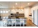 Contemporary kitchen featuring a spacious island, white cabinetry, and stylish pendant lights at 6817 Ebb Tide Ave, Apollo Beach, FL 33572