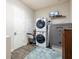 Spacious laundry room including washer, dryer, and a secure Winchester gun safe at 6817 Ebb Tide Ave, Apollo Beach, FL 33572