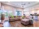 Spacious living room with a comfortable sectional sofa, wood floors, and seamless flow to the kitchen at 6817 Ebb Tide Ave, Apollo Beach, FL 33572