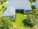Beautiful blue home featuring a screened in lanai and a large yard with manicured landscaping at 6817 Ebb Tide Ave, Apollo Beach, FL 33572