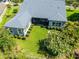 Beautiful blue home featuring a screened in lanai and a large yard with manicured landscaping at 6817 Ebb Tide Ave, Apollo Beach, FL 33572