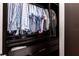 Dark stained wood walk-in closet features built-in drawers and hanging storage at 6817 Ebb Tide Ave, Apollo Beach, FL 33572