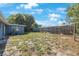 A spacious backyard is bordered by a wooden fence at 6834 Mesa Verde St, Port Richey, FL 34668