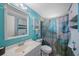 Inviting turquoise bathroom featuring a sink, a mirror, a toilet, and decorative nautical details at 6834 Mesa Verde St, Port Richey, FL 34668