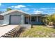 Charming single-story home featuring a garage and a welcoming front porch at 6834 Mesa Verde St, Port Richey, FL 34668