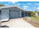 Single-story home with an attached garage, driveway and front porch at 6834 Mesa Verde St, Port Richey, FL 34668