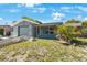 Single-story home featuring a garage and an enclosed front porch area at 6834 Mesa Verde St, Port Richey, FL 34668