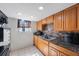 Traditional kitchen with granite countertops and tiled backsplash; great natural light from window at 6834 Mesa Verde St, Port Richey, FL 34668