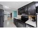 Well-lit black kitchen featuring oven, microwave, and white countertops at 6834 Mesa Verde St, Port Richey, FL 34668