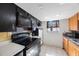Galley kitchen featuring an oven, microwave, tiled backsplash, and window at 6834 Mesa Verde St, Port Richey, FL 34668