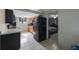 Functional kitchen featuring tiled floors and a black refrigerator at 6834 Mesa Verde St, Port Richey, FL 34668