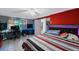 Bedroom includes a workspace and modern bed frame with unique red and grey decor at 6834 Mesa Verde St, Port Richey, FL 34668