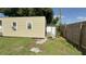 Image of a storage shed in the backyard, enclosed by a wooden fence, with a view of a well-maintained lawn at 7206 Reindeer Rd, Tampa, FL 33619