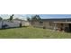 A spacious backyard featuring a well-maintained lawn and secure white vinyl fence, offering privacy and outdoor living space at 7206 Reindeer Rd, Tampa, FL 33619