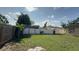 A fenced backyard with ample green space, creating a secure and private outdoor environment at 7206 Reindeer Rd, Tampa, FL 33619