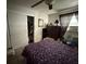 Comfortable bedroom with a patterned duvet, closet, and window unit visible at 7206 Reindeer Rd, Tampa, FL 33619