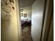 Bedroom entrance showing a ceiling fan and decoratively furnished bedroom with a plush bed at 7206 Reindeer Rd, Tampa, FL 33619