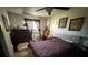 Bright bedroom with patterned duvet, ceiling fan, and decorative wall art at 7206 Reindeer Rd, Tampa, FL 33619
