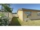 Side view of the home's exterior, showcasing the backyard area and partial privacy fencing at 7206 Reindeer Rd, Tampa, FL 33619
