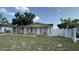 View of the house showcasing a white picket fence and an inviting front porch with classic design elements at 7206 Reindeer Rd, Tampa, FL 33619