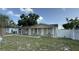 Front exterior view of this house with white pillars, a manicured lawn, and a quaint front porch seating area at 7206 Reindeer Rd, Tampa, FL 33619