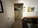 View of a tiled hallway with wall art and a view into a living room space at 7206 Reindeer Rd, Tampa, FL 33619