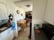 View into kitchen and living room from the kitchen area, with a dog visible in the living room at 7206 Reindeer Rd, Tampa, FL 33619