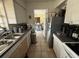 Kitchen area with white cabinets and a stainless steel refrigerator with tile floors and doorway view at 7206 Reindeer Rd, Tampa, FL 33619