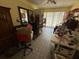 Bright yellow room with tile floors, mirrors, sewing accessories, and a ceiling fan at 7206 Reindeer Rd, Tampa, FL 33619
