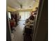 Bright room with a ceiling fan, sliding glass doors, tile floors, and sewing items throughout at 7206 Reindeer Rd, Tampa, FL 33619