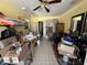 Bright yellow room with sewing tables and accessories; with view into the hallway and adjacent room at 7206 Reindeer Rd, Tampa, FL 33619