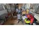 Unfinished room with exposed walls, disorganized items, and makeshift shelving at 7206 Reindeer Rd, Tampa, FL 33619